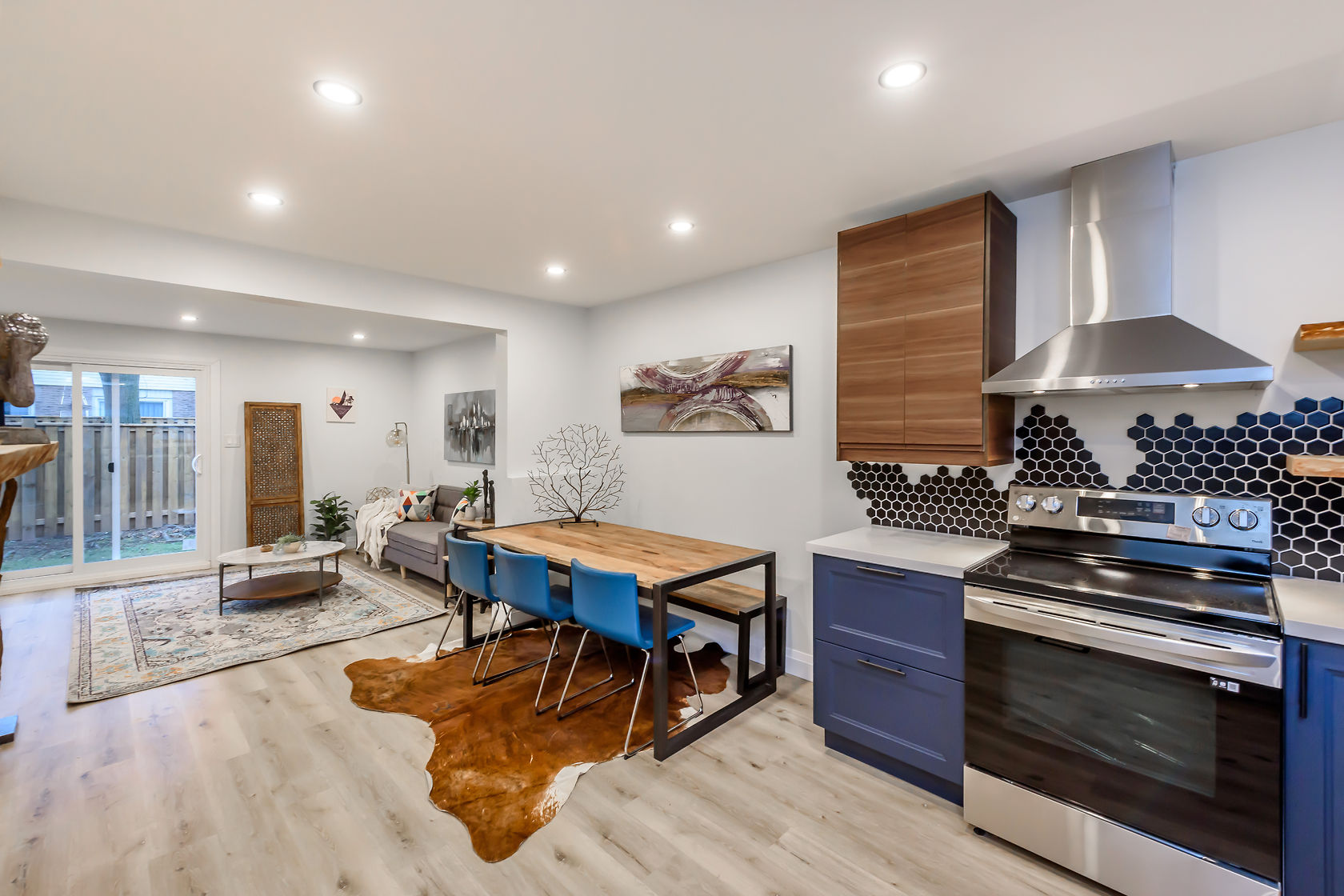 Premium wide-angle finished kitchen with striking blue cabinets, hexagon backsplash, and open-concept flow — Gateshead, Hamilton | MTC Renovations